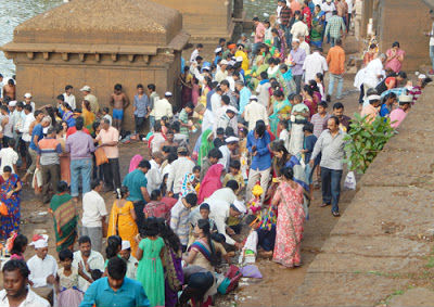 Several devotees gathered at ghat for immersion of idols in flowing water !
