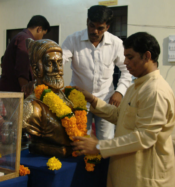 Mr. Ramesh Shinde garlanding the statue of Shivaji Maharaj